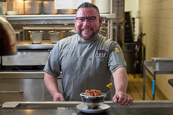 Chef Smiling in Front of Shrimp Cocktail